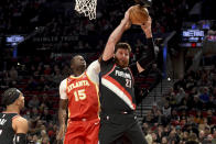 Portland Trail Blazers center Jusuf Nurkic, right, grabs a rebound over Atlanta Hawks center Clint Capela (15) during the first half of an NBA basketball game in Portland, Ore., Monday, Jan. 30, 2023. (AP Photo/Steve Dykes)