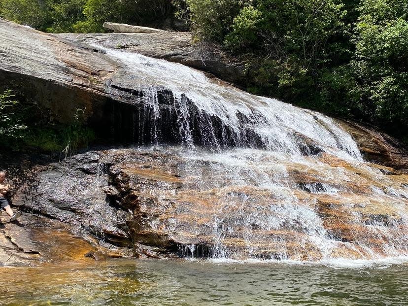 A waterfall surrounded by trees.