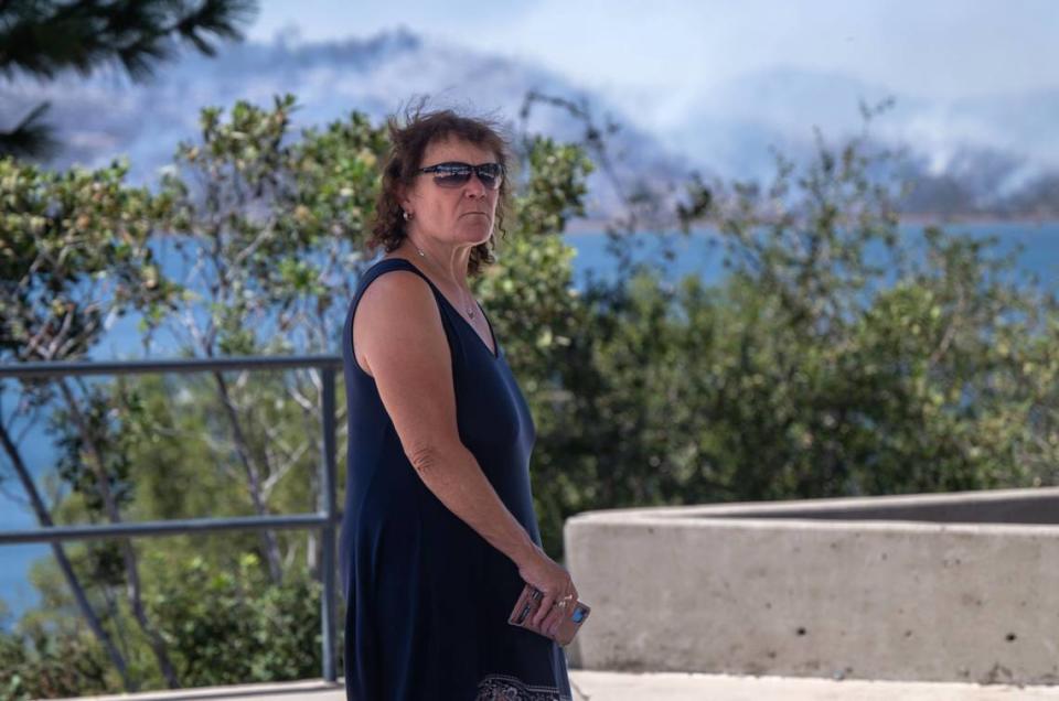 Renée Marshall looks at the Thompson Fire from her home on Kelly Ridge near Oroville on Wednesday. Marshall said she survived the Camp Fire and would like to see evacuations lifted as she believes the fire is no longer a threat to homes in her neighborhood.