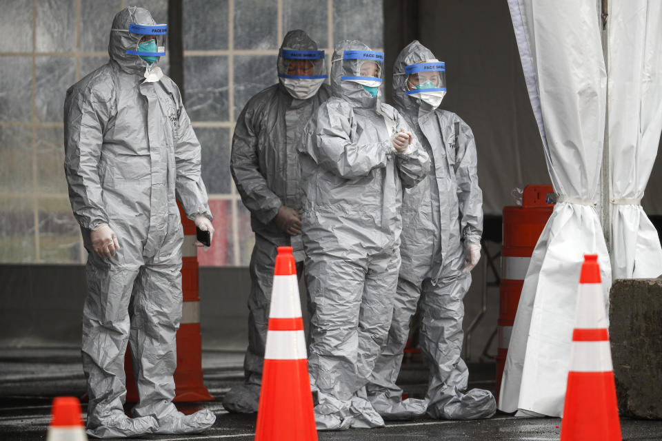 FILE - Medical personnel await patients for COVID-19 coronavirus testing facility at Glen Island Park, Friday, March 13, 2020, in New Rochelle, N.Y. Some states that stockpiled millions of masks and other personal protective equipment during the coronavirus pandemic are now throwing the items away. (AP Photo/John Minchillo, File)