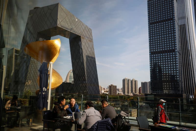 People eat lunch at a terrace restaurant near the CCTV building in the Central Business District (CBD) following an outbreak of the coronavirus disease (COVID-19) in Beijing