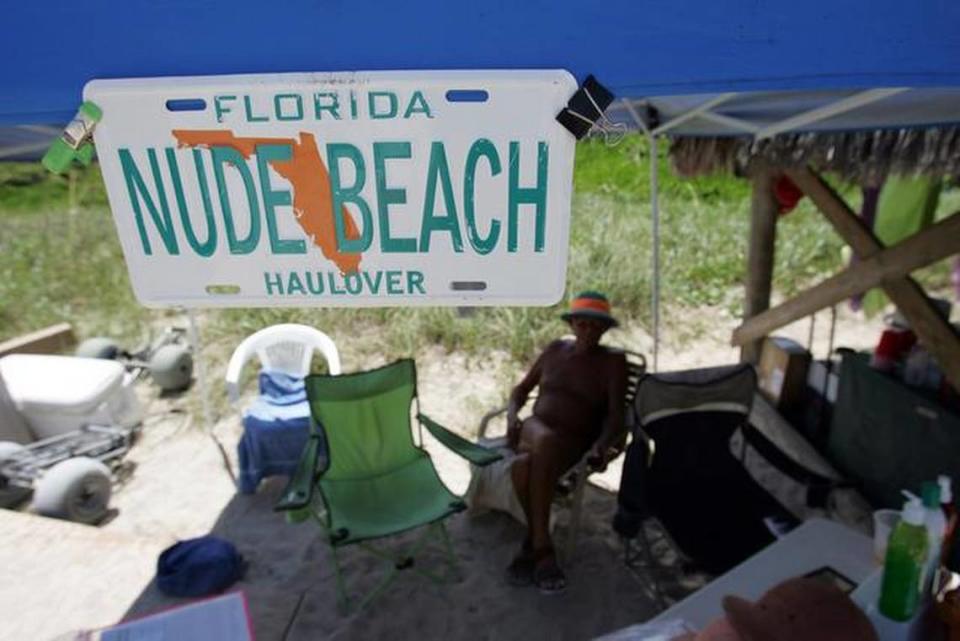 A man sits at the concession stand on a stretch of Haulover Beach open to nude bathers.