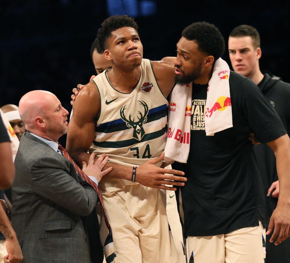 Bucks forward Giannis Antetokounmpo is helped off the court after injuring his right ankle Feb. 4, 2018, against Brooklyn Nets at Barclays Center. Antetokounmpo did not miss any additional games.