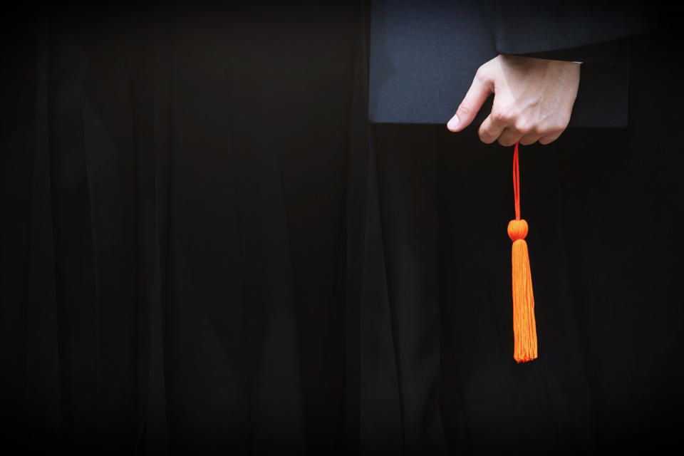 hand holding a graduation cap