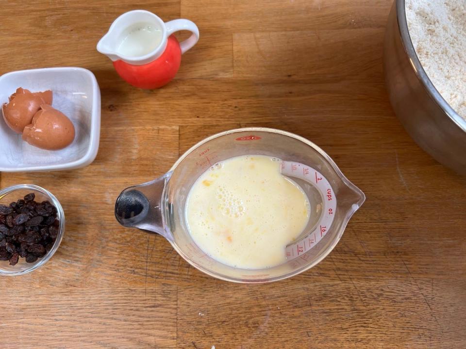 An overhead view shows a milk and egg mixture in a Pyrex measuring jug.