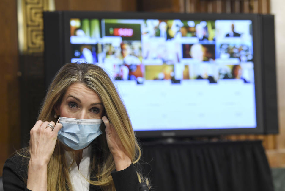 Sen. Kelly Loeffler, R-Ga., removes her mask before the Senate Committee for Health, Education, Labor, and Pensions hearing, Tuesday, May 12, 2020 on Capitol Hill in Washington. Dr. Anthony Fauci, director of the National Institute of Allergy and Infectious Diseases, is to testify before the committee. (Toni L. Sandys/The Washington Post via AP, Pool)