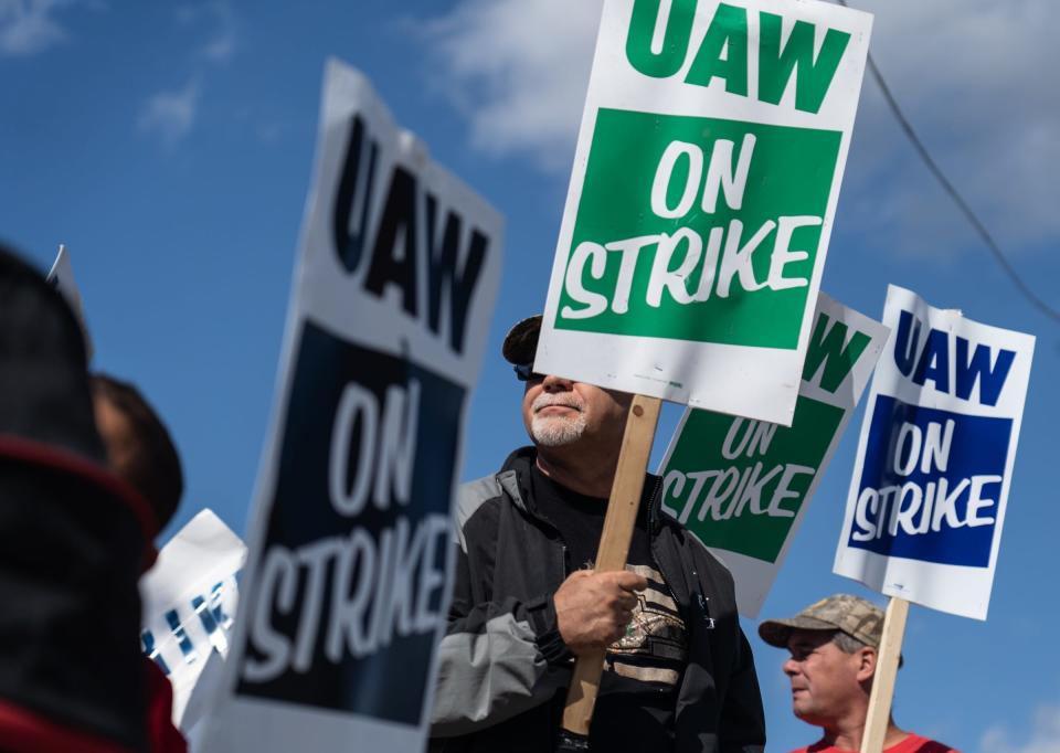 UAW members stand on the picket line outside of the north gate of General Motors Flint Assembly on Monday, October 7, 2019 as they remain on strike from General Motors.