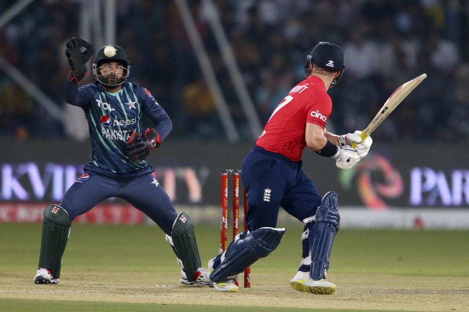 Pakistan's Mohammad Rizwan, left, attempts to run out to England's Ben Duckett during the seventh twenty20 cricket match between Pakistan and England, in Lahore, Pakistan, Sunday, Oct. 2, 2022. (AP Photo/K.M. Chaudary)