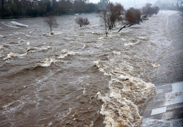 PHOTO: The Los Angeles River, swollen by storm runoff, flows strongly downstream toward the Pacific Ocean on Feb. 24, 2023, in Los Angeles. (Mario Tama/Getty Images)