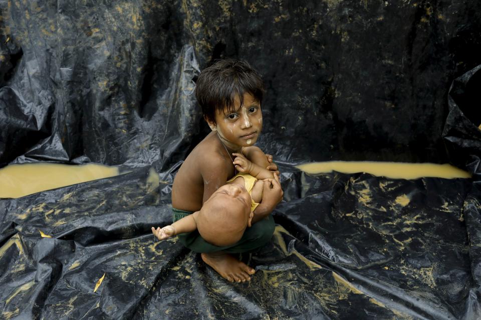 A Rohingya child holds a baby after arriving at a refugee camp near Teknaf, Bangladesh, on Sept. 5, 2017. (Photo: K M ASAD via Getty Images)