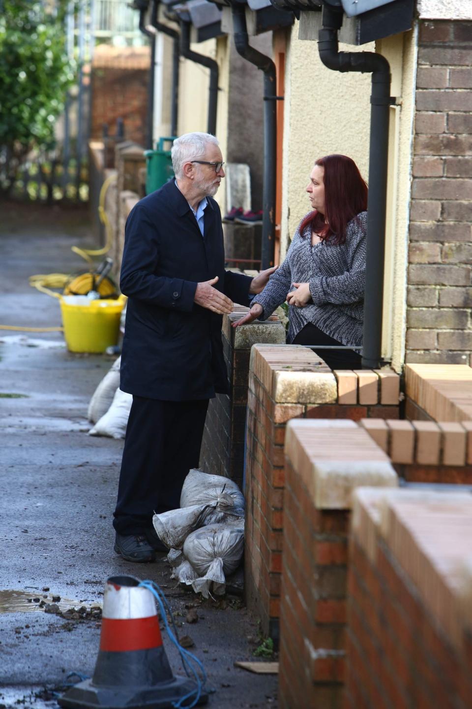 Labour Party leader Jeremy Corbyn meets resident Theresa Davies who has been affected by flooding in south Wales (AFP via Getty Images)