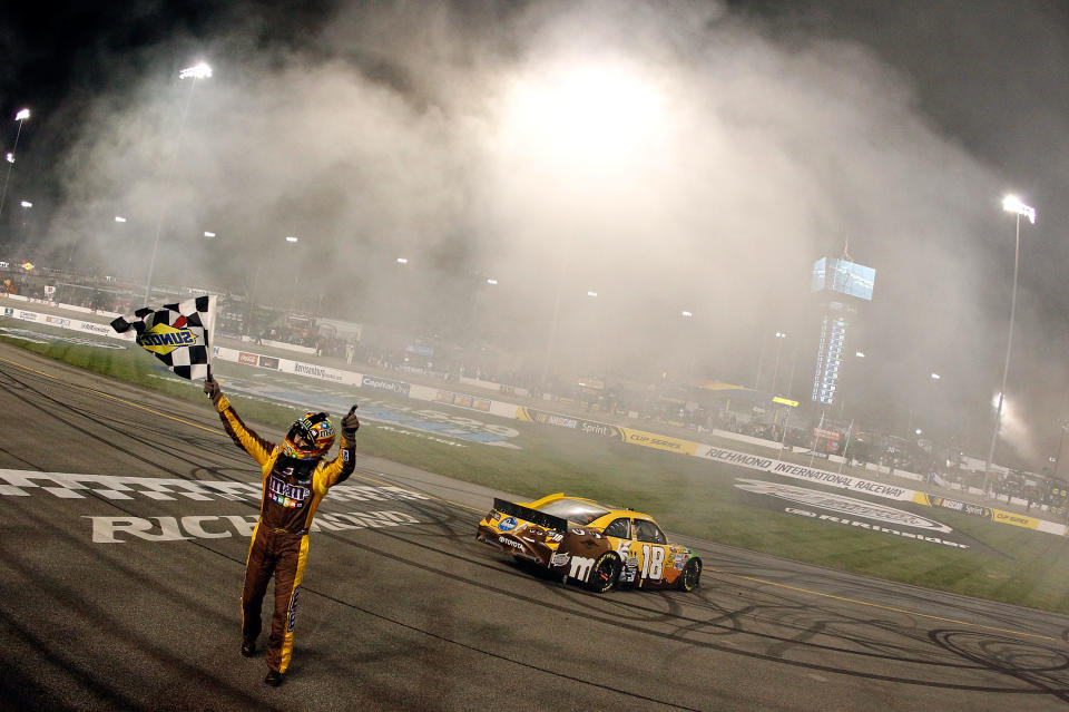 RICHMOND, VA - APRIL 28: Kyle Busch, driver of the #18 M&M's Ms. Brown Toyota, celebrates with the checkered flag after winning the NASCAR Sprint Cup Series Capital City 400 at Richmond International Raceway on April 28, 2012 in Richmond, Virginia. (Photo by Tom Pennington/Getty Images for NASCAR)