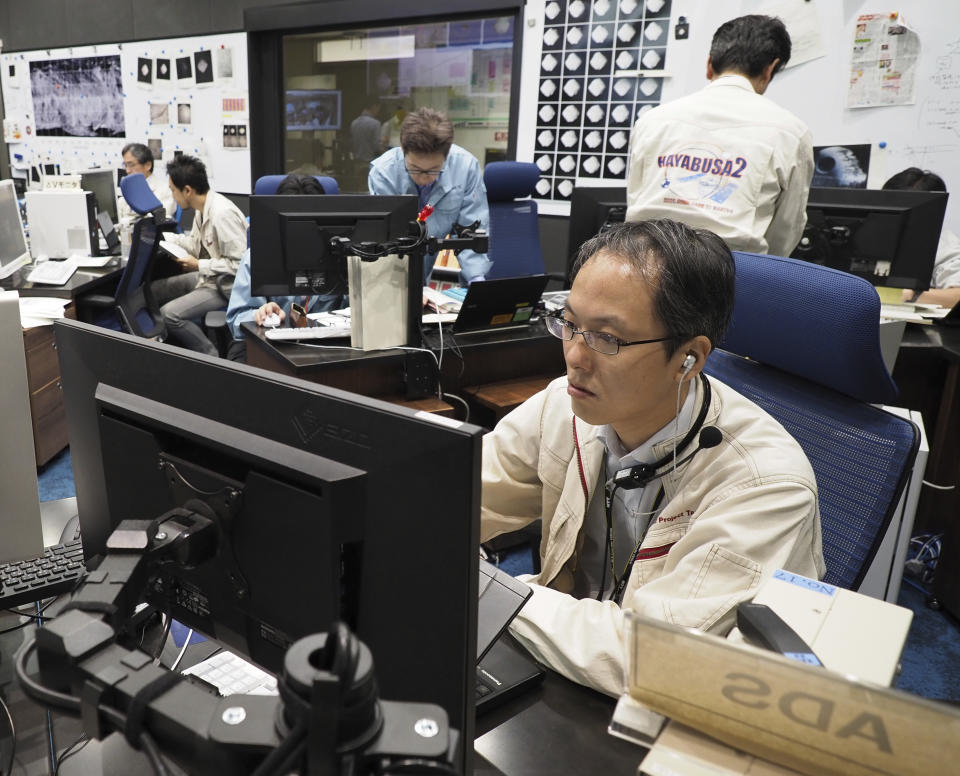 This Oct. 3, 2018, photo provided by the Japan Aerospace Exploration Agency (JAXA) shows JAXA's Hayabusa project manager, Yuichi Tsuda at JAXA Institute of Space and Astronautical Science in Sagamihara, near Tokyo. Japan’s space agency is delaying a spacecraft touchdown on an asteroid as scientists need more time to find a safe landing site on the extremely rocky surface. (JAXA via AP)