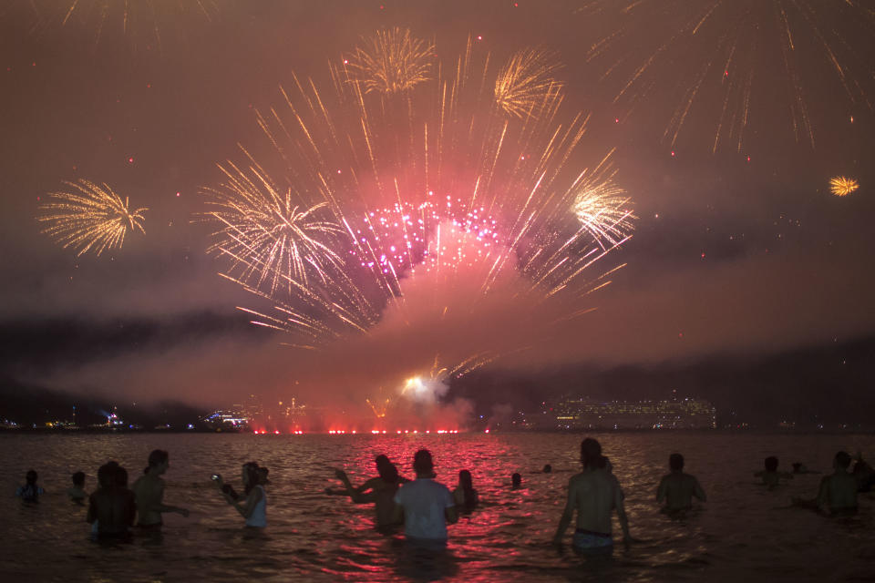 People watch fireworks during New Year's celebrations at Copacabana beach in Rio de Janeiro on January 1, 2018. (Photo: MAURO PIMENTEL via Getty Images)