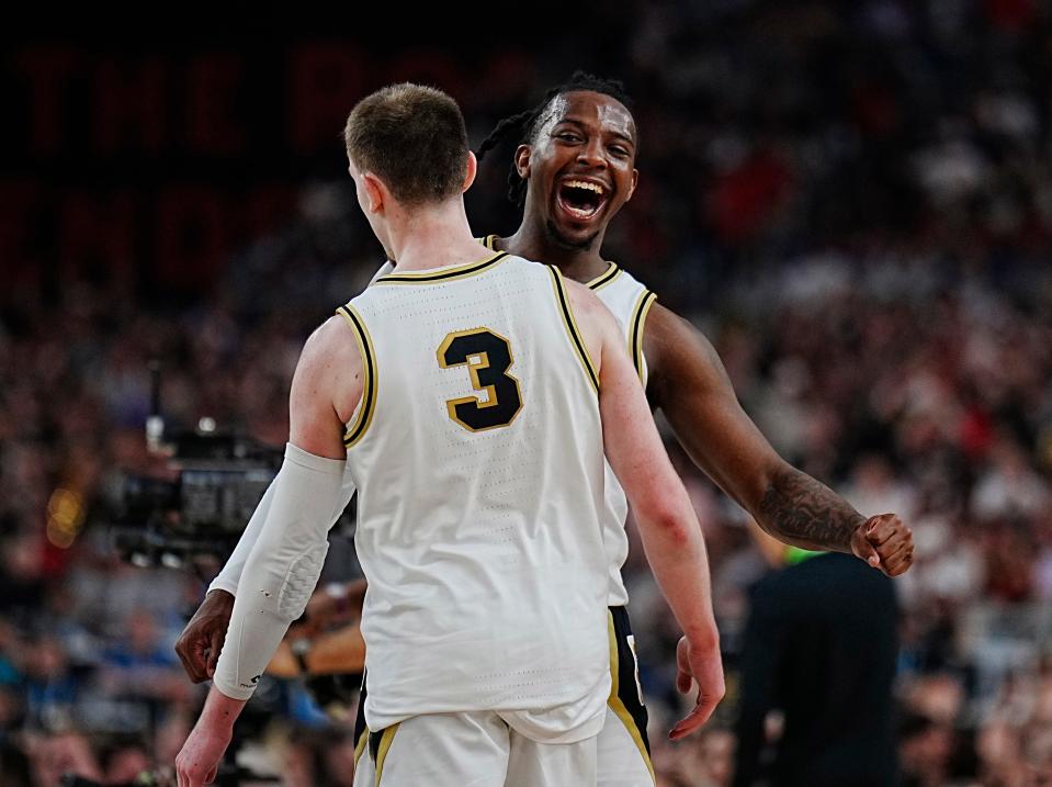 Purdue guard Lance Jones (55) celebrates a three point basket by guard Braden Smith (3) against North Carolina State during the Final Four semifinal game at State Farm Stadium.