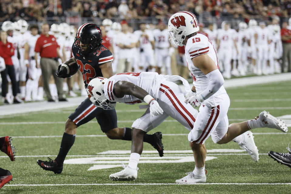 Ohio State running back TreVeyon Henderson, left, cuts upfield against Wisconsin linebacker Jordan Turner, center, and defensive back John Torchio, right, during the first half of an NCAA college football game Saturday, Sept. 24, 2022, in Columbus, Ohio. (AP Photo/Jay LaPrete)