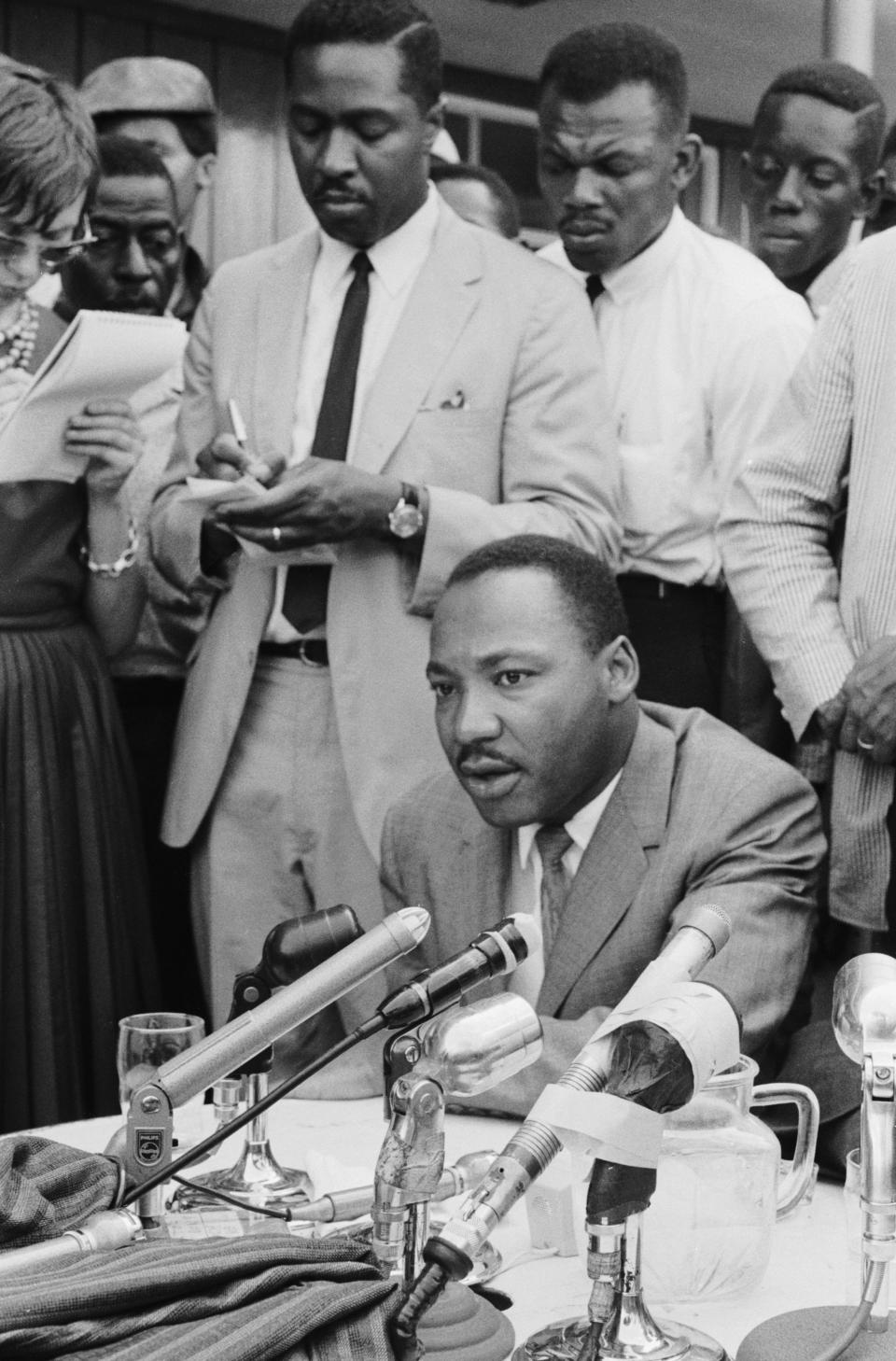 The Rev. Martin Luther King Jr. at a news conference in Birmingham, Ala., in 1963. Taking notes behind him is his speechwriter, Clarence B. Jones.