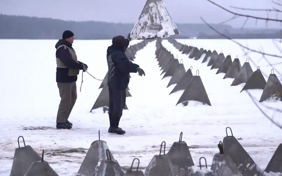 The concrete defences stretch into the horizon near the Belarus border