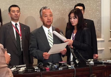Japanese trade minister Akira Amari (centre) speaks to media during a break in the Trans-Pacific Partnership talks in Atlanta, Georgia October 3, 2015. REUTERS/Kevin Fogarty