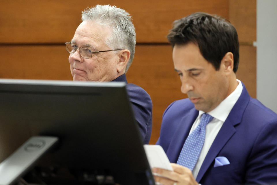 Former Marjory Stoneman Douglas High School School Resource Officer Scot Peterson, left, seated at the defense table with defense attorney Mark Eiglarsh, shakes his head as Sunrise Police Lt. Craig Cardinale (not shown) testifies during Peterson's trial at the Broward County Courthouse in Fort Lauderdale, Fla., on Tuesday, June 20, 2023. Broward County prosecutors charged Peterson, a former Broward Sheriff's Office deputy, with criminal charges for failing to enter the 1200 Building at the school and confront the shooter. Cardinale's son was in the building at the time of the shooting and Cardinale responded to the high school. (Amy Beth Bennett/South Florida Sun-Sentinel via AP, Pool)
