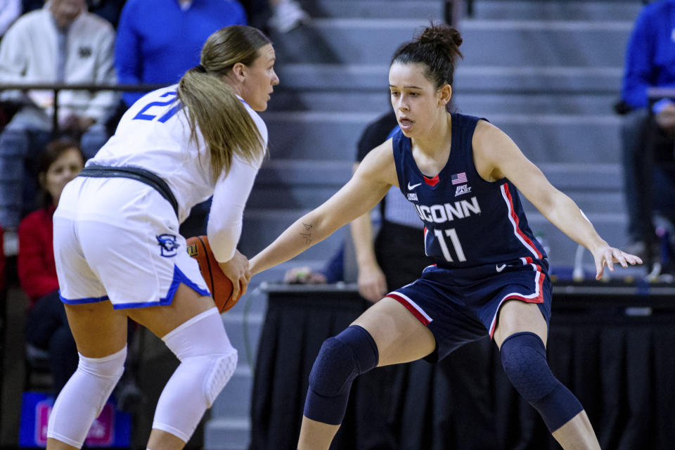 UConn's Lou Lopez-Senechal (11) guards Creighton's Molly Mogensen (21) during the first half of an NCAA college basketball game Wednesday, Dec. 28, 2022, in Omaha, Neb. (AP Photo/John Peterson)