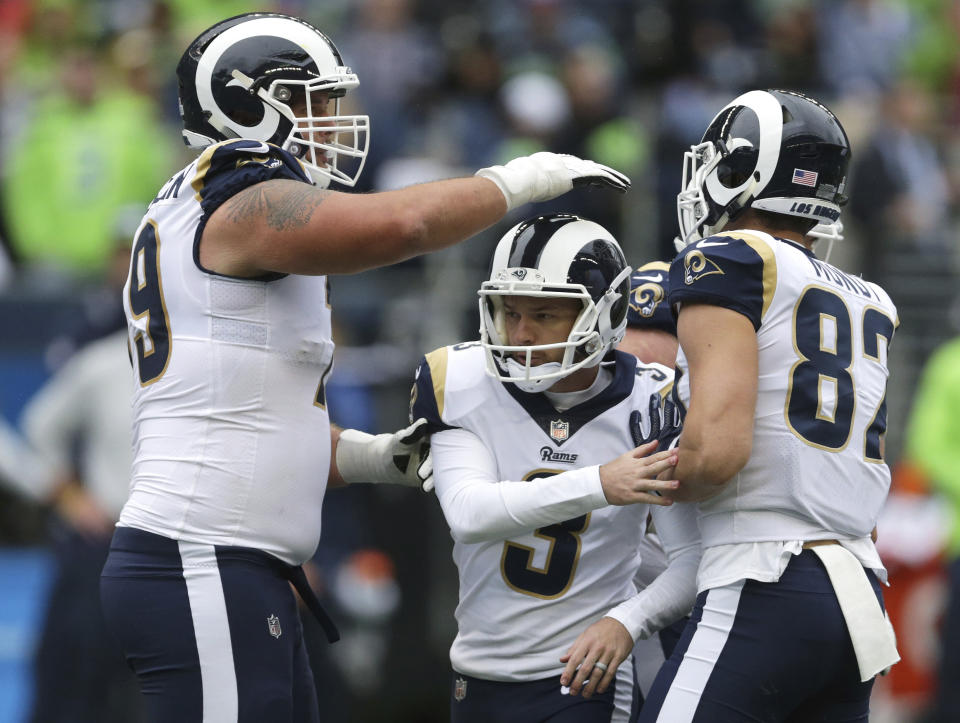 Los Angeles Rams kicker Cairo Santos (3) is greeted by Rob Havenstein, left, and Johnny Mundt, right, after kicking a field goal during the second half of an NFL football game against the Seattle Seahawks, Sunday, Oct. 7, 2018, in Seattle. (AP Photo/Scott Eklund)