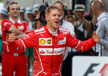 Formula One - F1 - Australian Grand Prix - Melbourne, Australia - 26/03/2017 - Ferrari driver Sebastian Vettel of Germany reacts in the pits after winning the Australian Formula One Grand Prix. REUTERS/Mark Horsburgh