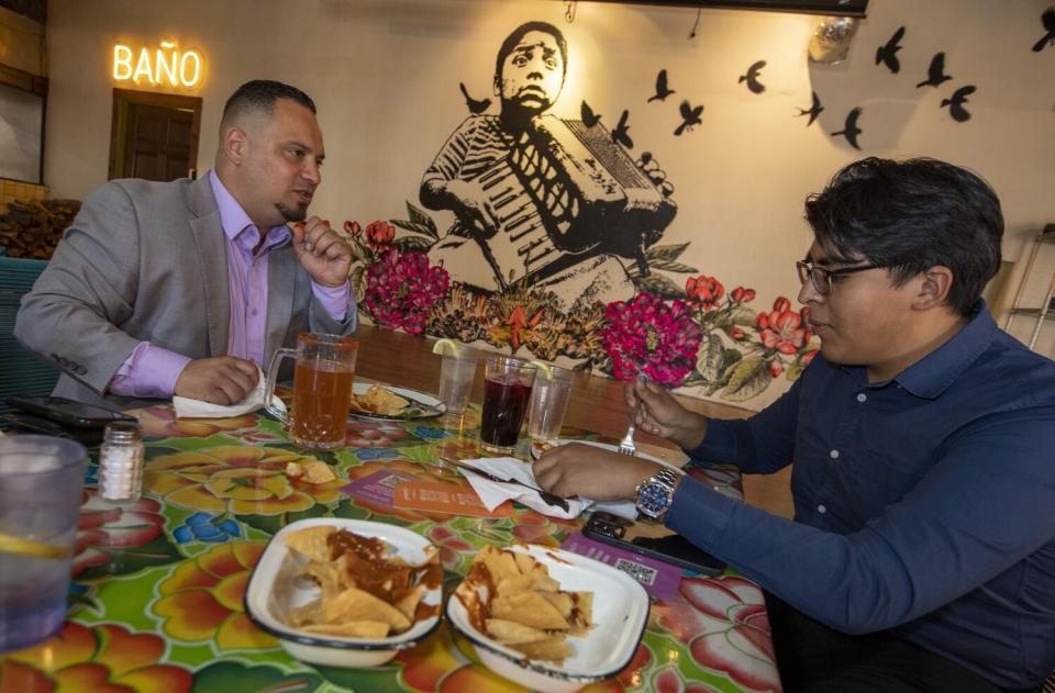 Two people share a meal at Guelaquetza Restaurant in Koreatown.