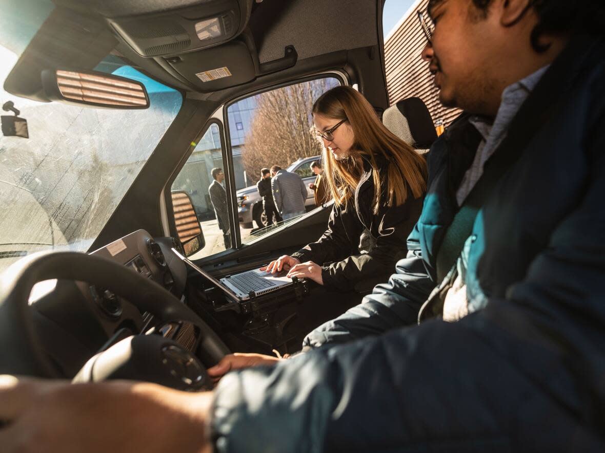 Two UBC students drive the pollution-detecting PLUME van around Vancouver. (Paul Joseph/UBC Mechanical Engineering - image credit)