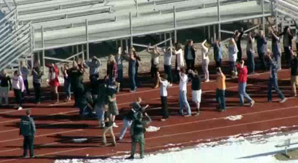 Students from Arapahoe High School evacuate their building in Centennial