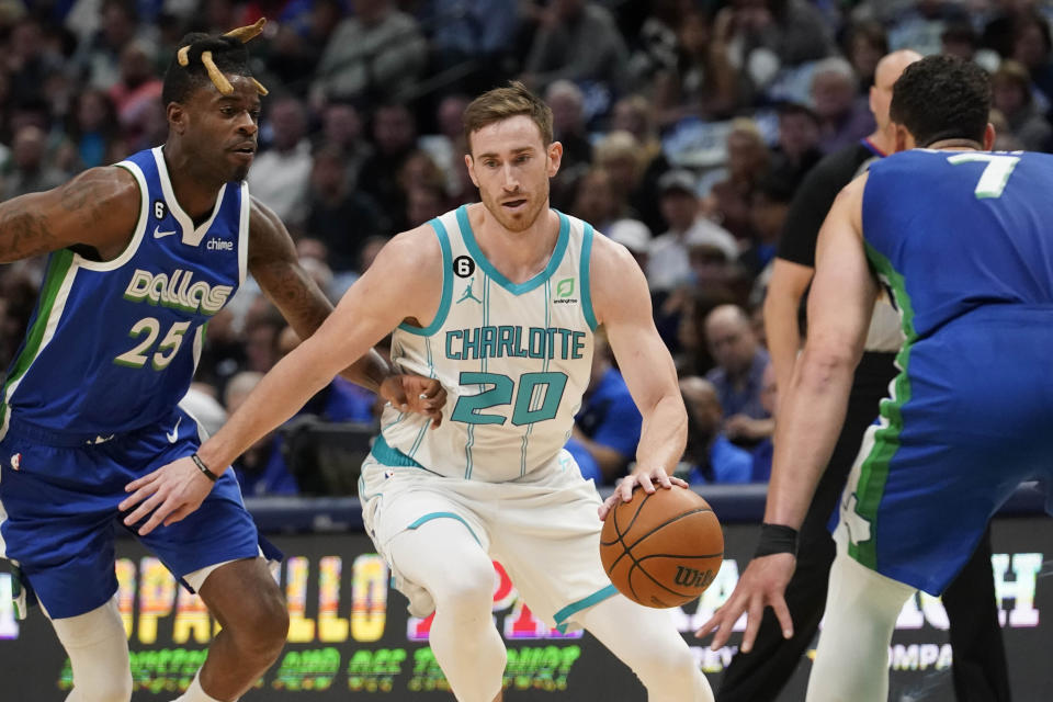 Charlotte Hornets forward Gordon Hayward (20) drives against Dallas Mavericks defenders Reggie Bullock (25) and Dwight Powell (7) during the first quarter of an NBA basketball game in Dallas, Friday, March 24, 2023. (AP Photo/LM Otero)