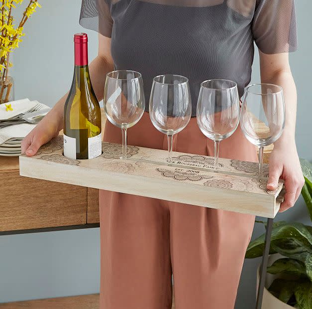 Find this <a href="https://fave.co/3nnOA8M" target="_blank" rel="noopener noreferrer">Personalized Wine Serving Tray for $85</a> at Uncommon Goods.