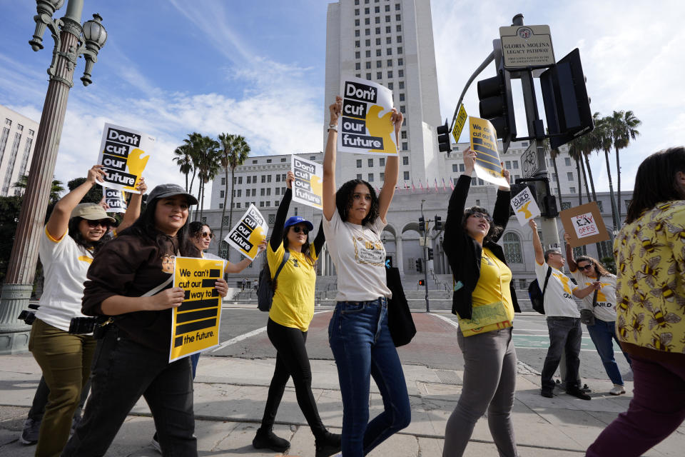 Members of the Los Angeles Times Guild carry signs and chant slogans in front of Los Angeles City Hall on Friday, Jan. 19, 2024. Guild members of the Los Angeles Times participated in one-day walkout to protest imminent layoffs. The job action Friday is the first newsroom union work stoppage in the history of the newspaper, which began printing in 1881. (AP Photo/Richard Vogel)