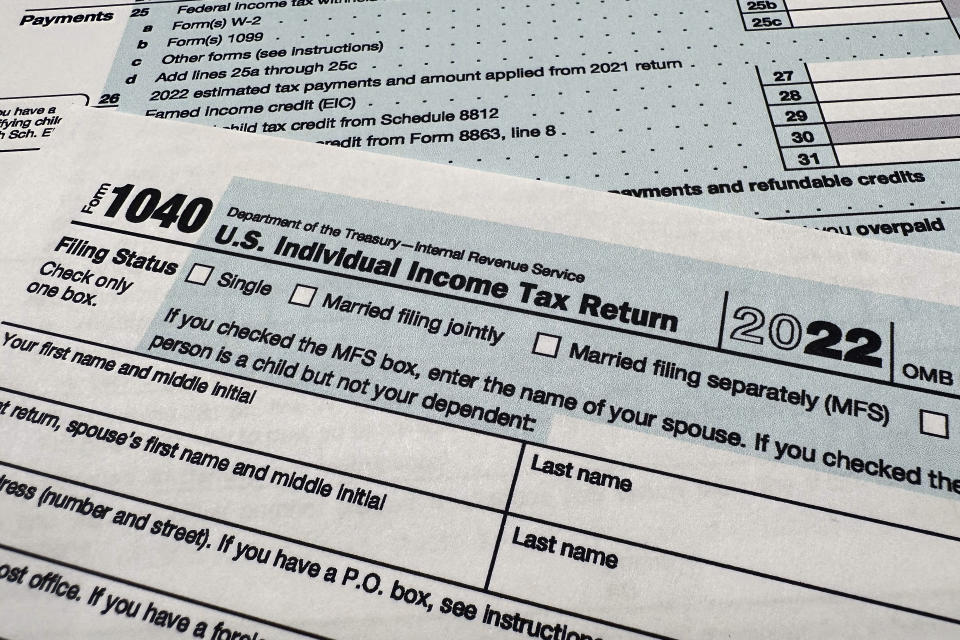 FILE - The Internal Revenue Service 1040 tax form for 2022 is seen on April 17, 2023. GOP lawmakers are pushing deep tax cuts for companies and the affluent as the primary driver for sustaining economic growth, while President Joe Biden and Democrats seek more targeted tax cuts to achieve social goals such as reducing child poverty and shifting to renewable energy that can help the economy in the long run. It's a set of differences that will come to the forefront in 2025, when the debt limit drama returns and tax cuts passed in 2017 are due to expire. (AP Photo/Jon Elswick, File)