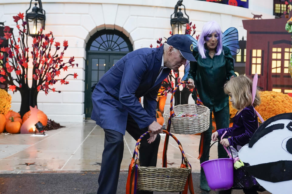 President Joe Biden and first lady Jill Biden give treats to trick-or-treaters on the South Lawn of the White House, on Halloween, Monday, Oct. 31, 2022, in Washington. (AP Photo/Alex Brandon)