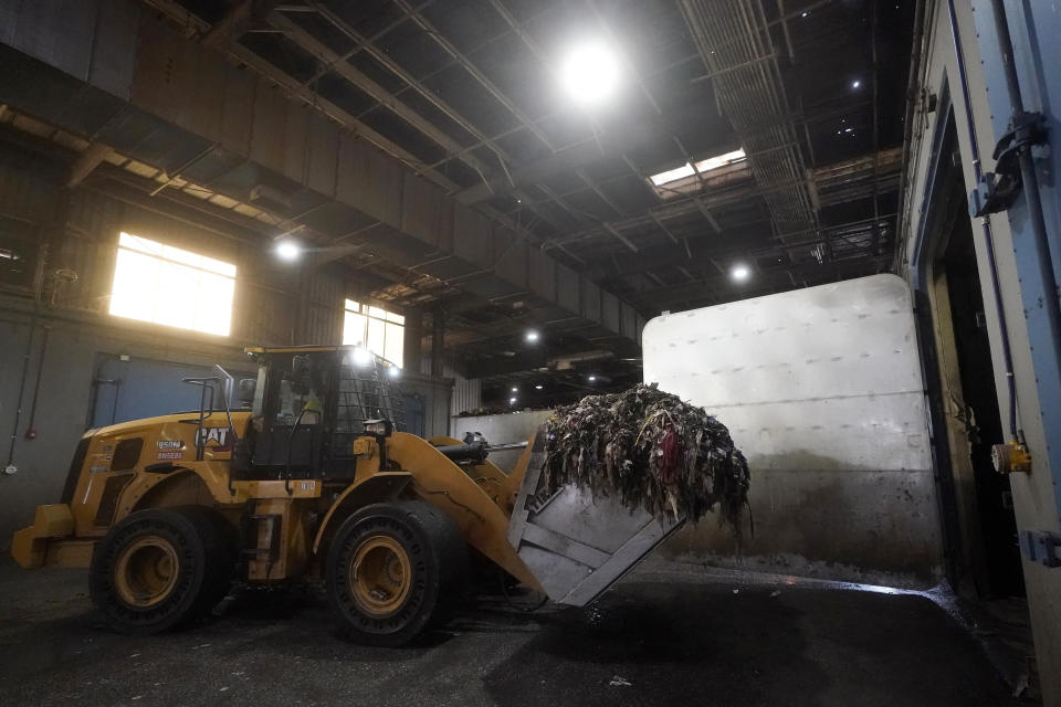 Organic material is demonstrated being loaded into a digester at a GreenWaste Zanker Resource Recovery Facility in San Jose, Calif., Friday, Oct. 27, 2023. A pair of recent reports from the EPA put striking numbers to the problem of food waste: one-third of the food produced in the U.S. is never eaten. California began requiring every jurisdiction to provide organic waste collection services starting in 2022. (AP Photo/Jeff Chiu)