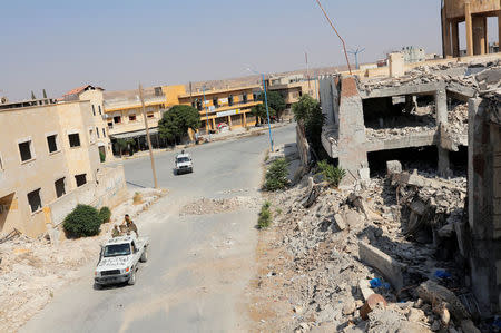 Members of Turkish-backed Free Syrian Army (FSA) patrol in the border town of Jarablus, Syria, August 31, 2016. REUTERS/Umit Bektas