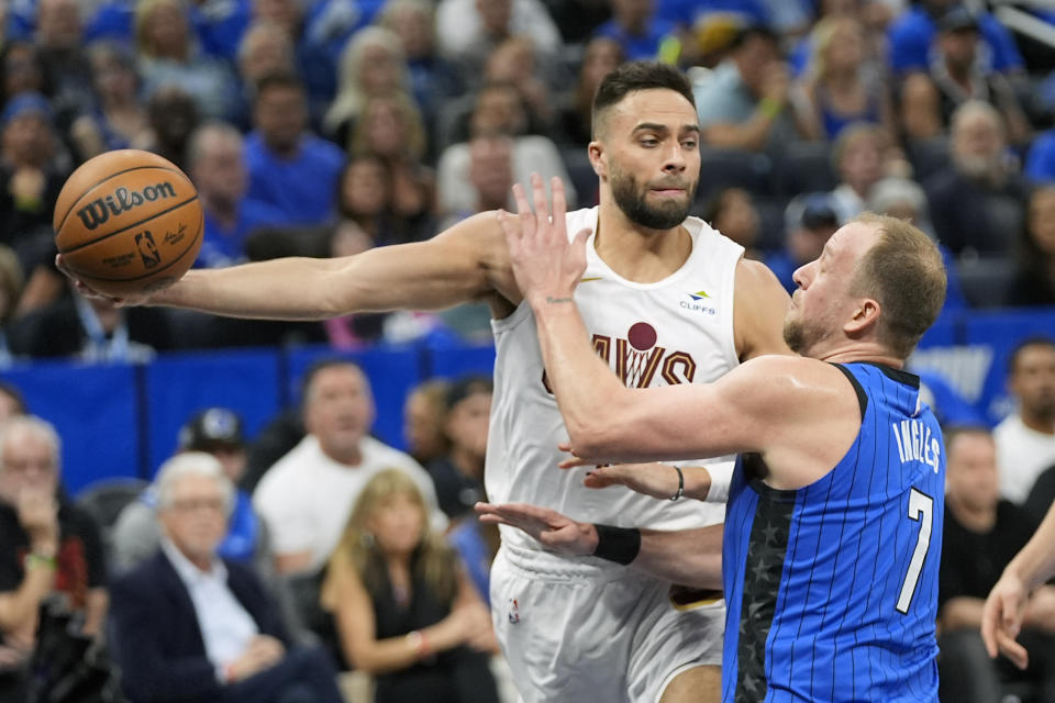 Cleveland Cavaliers guard Max Strus, left, passes the ball around Orlando Magic guard Joe Ingles (7) during the first half of Game 6 of an NBA basketball first-round playoff series, Friday, May 3, 2024, in Orlando, Fla. (AP Photo/John Raoux)