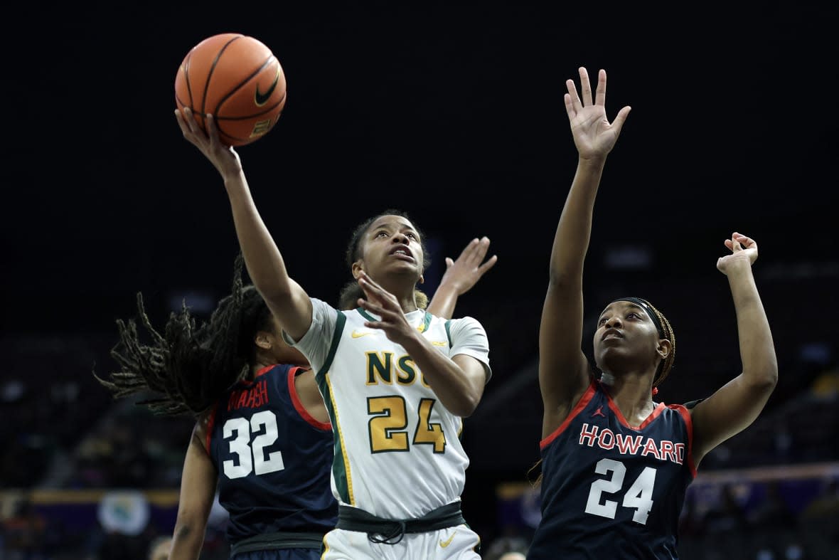 NORFOLK, VIRGINIA – MARCH 11: Da’naijah Williams #24 of the Norfolk State Spartans shoots a lay up between Krislyn Marsh #32 and Brooklynn Fort-Davis #24 of the Howard Lady Bison during the first half during the 2023 MEAC Women’s Basketball Tournament Semifinals at Norfolk Scope Arena on March 11, 2023 in Norfolk, Virginia. (Photo by Tim Nwachukwu/Getty Images)