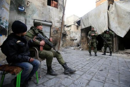 Russian soldiers carry their weapons in the Old City of Aleppo, Syria January 31, 2017. REUTERS/Ali Hashisho