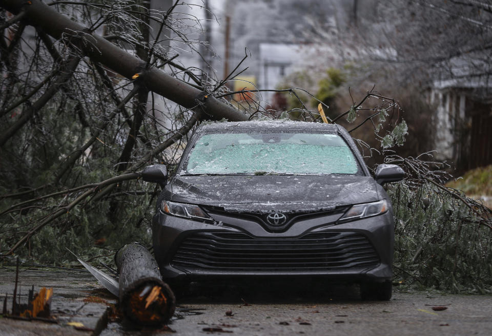 A fallen tree and powerline sits on a car Thursday, Feb. 3, 2022 in Memphis, Tenn. A major winter storm that already cut electric power to about 350,000 homes and businesses from Texas to the Ohio Valley was set to leave Pennsylvania and New England glazed in ice and smothered in snow.(Patrick Lantrip/Daily Memphian via AP)