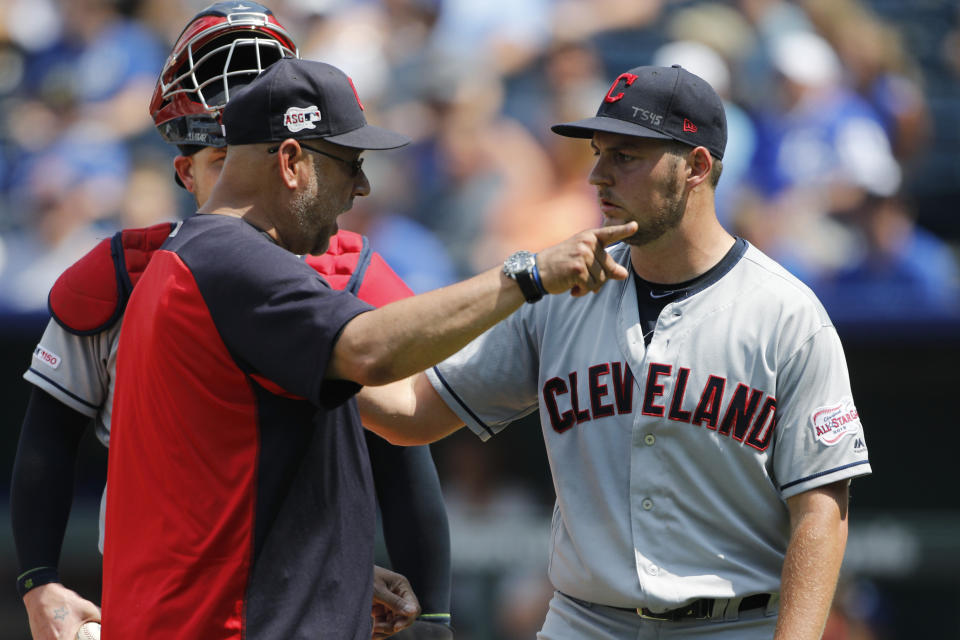 Cleveland Indians manager Terry Francona, left, has words with pitcherTrevor Bauer, right, as Bauer is taken out in the fifth inning of a baseball game against the Kansas City Royals at Kauffman Stadium in Kansas City, Mo., Sunday, July 28, 2019. Bauer threw two baseballs into the stands as he reacted to Royals batter Nicky Lopez's two-RBI single. (AP Photo/Colin E. Braley)