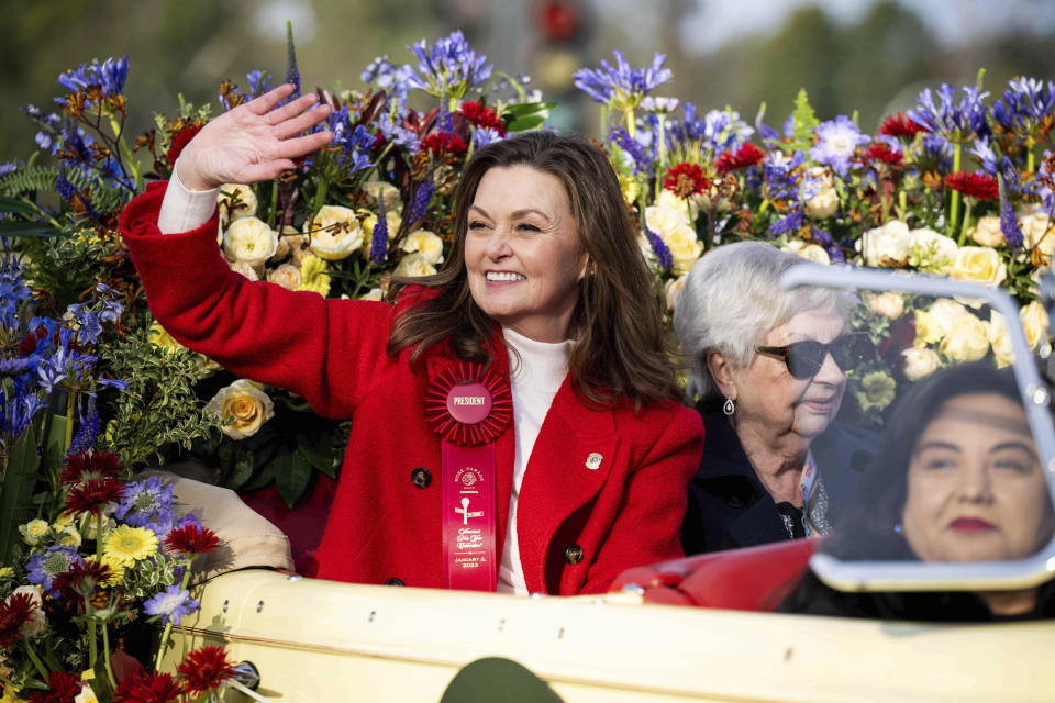 Pasadena Tournament of Roses Association President Amy Wainscott waves along Colorado Boulevard during the 134th Rose Parade in Pasadena, Calif., Monday, Jan. 2, 2023. (Sarah Reingewirtz/The Orange County Register via AP)