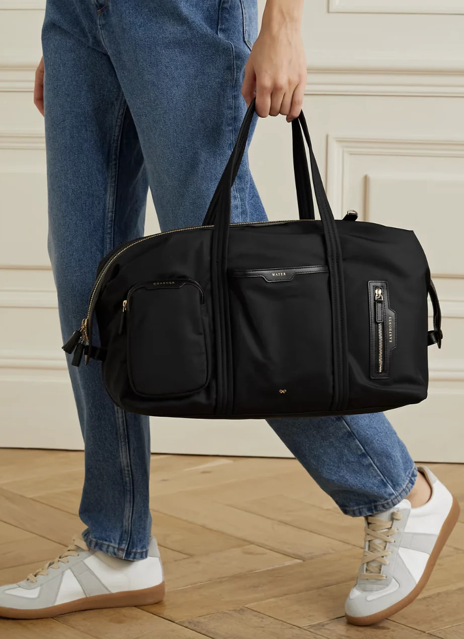 Anya Hindmarch NET SUSTAIN Inflight leather-trimmed recycled shell weekend bag. PHOTO: Net-A-Porter