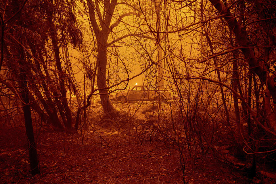 A scorched car rests in a clearing following the Bear Fire in Butte County, Calif., on Wednesday, Sept. 9, 2020. The blaze, part of the lightning-sparked North Complex, expanded at a critical rate of spread as winds buffeted the region. (AP Photo/Noah Berger)