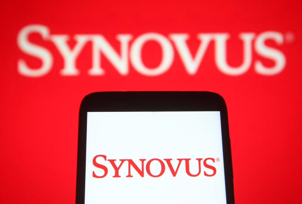 UKRAINE - 2021/06/26: In this photo illustration a Synovus Financial Corporation logo is seen on a smartphone and a pc screen. (Photo Illustration by Pavlo Gonchar/SOPA Images/LightRocket via Getty Images)