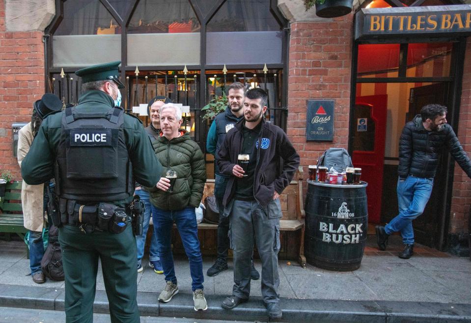 A police officer with bar patrons