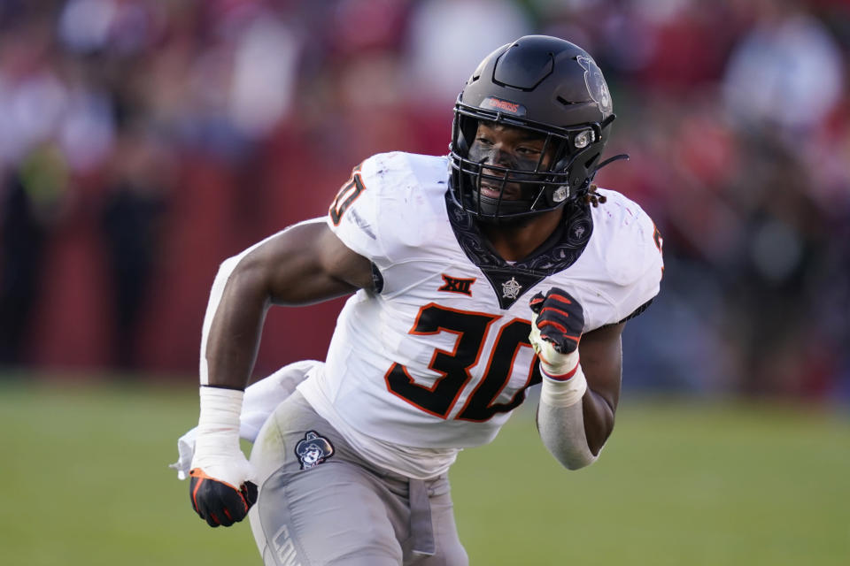 FILE - Oklahoma State defensive end Collin Oliver (30) runs on the field during the second half of an NCAA college football game against Iowa State, on Oct. 23, 2021, in Ames, Iowa. Oliver led the Big 12 with 11.5 sacks as a true freshman last season. (AP Photo/Charlie Neibergall, File)