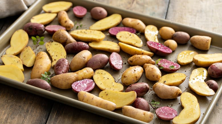 raw fingerling potatoes on a baking sheet