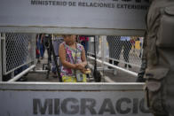 Esmeralda Lugo waits for her father Carlos Lugo on the Simon Bolivar International Bridge to cross between San Antonio, Venezuela, behind, and Cucuta, Colombia, Friday, Aug. 5, 2022, on the border that is open to pedestrian traffic but closed to cargo trucks. "I leave my daughter off at a day care center in Colombia to work moving the luggage of people crossing. On a good day, I can earn about $20 dollars", says Gomez. (AP Photo/Matias Delacroix)